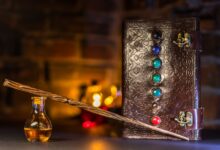 Close-up of a wizard's wand and potion with a magical spell book on a rustic background.