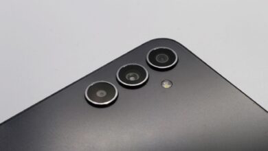 Close-up of a sleek smartphone with triple camera lenses and matte finish.