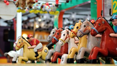 Vibrant carousel of toy horses in an amusement park setting, perfect for family fun themes.
