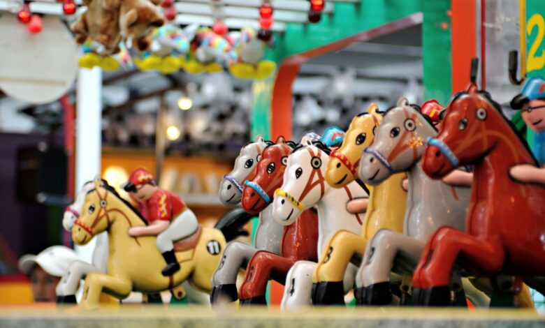 Vibrant carousel of toy horses in an amusement park setting, perfect for family fun themes.