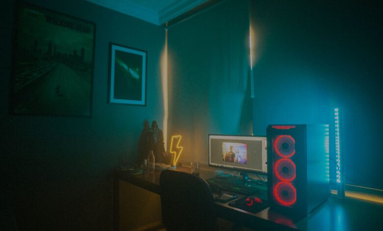 A dimly lit minimalist gaming setup featuring a desktop PC and neon lights.