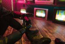 Futuristic cyberpunk vibe with a prosthetic hand holding a gaming joystick. Neon lights and retro TVs.