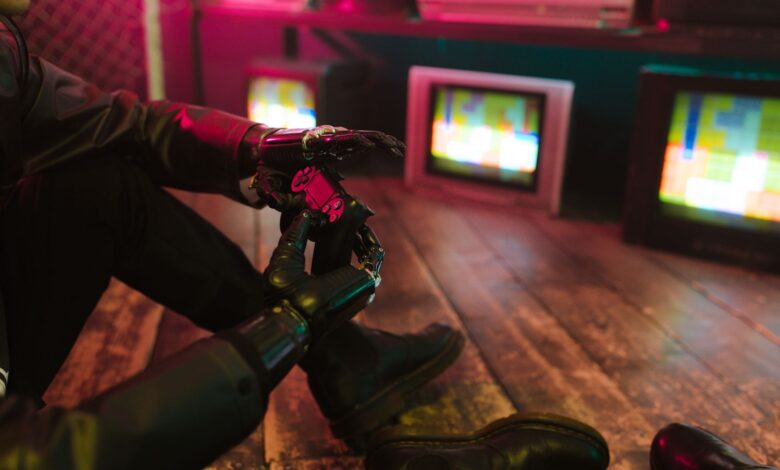 Futuristic cyberpunk vibe with a prosthetic hand holding a gaming joystick. Neon lights and retro TVs.