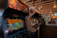 Modern arcade machines with bright luminous monitors and inscriptions in contemporary public entertainment center