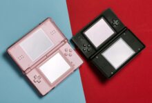 Pink and black Nintendo DS consoles displayed on contrasting red and blue backgrounds.