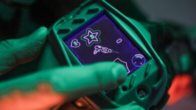 A close-up view of a laser tag device screen during a game session indoors.