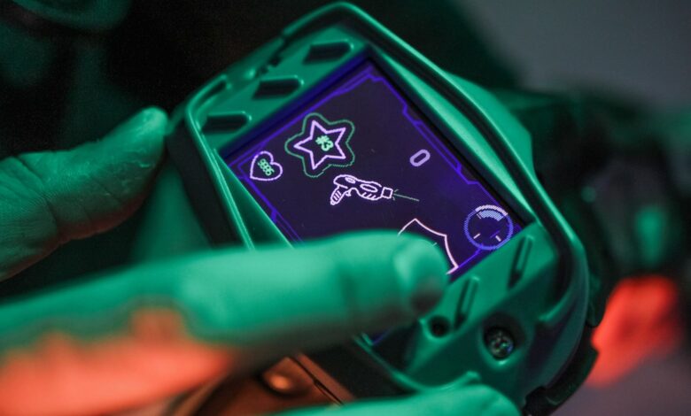A close-up view of a laser tag device screen during a game session indoors.