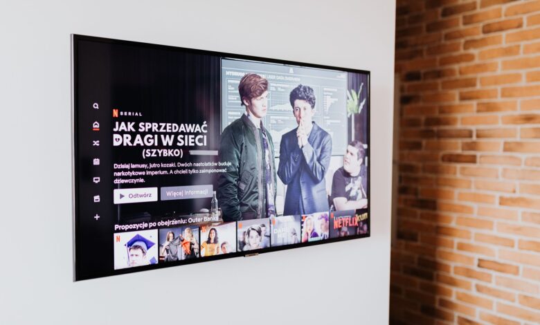 Smart TV displaying streaming content in modern living room setting with exposed brick wall.