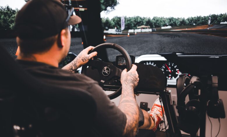 Focused gamer experiencing a detailed driving simulation setup indoors.