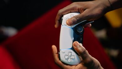 Hands gripping a wireless game controller, showcasing modern technology and gaming.