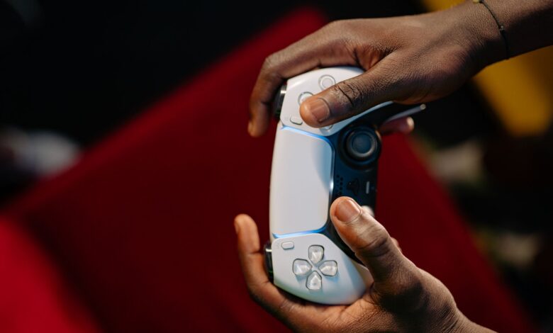 Hands gripping a wireless game controller, showcasing modern technology and gaming.