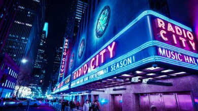 Iconic Radio City Music Hall with neon lights at night in New York City.