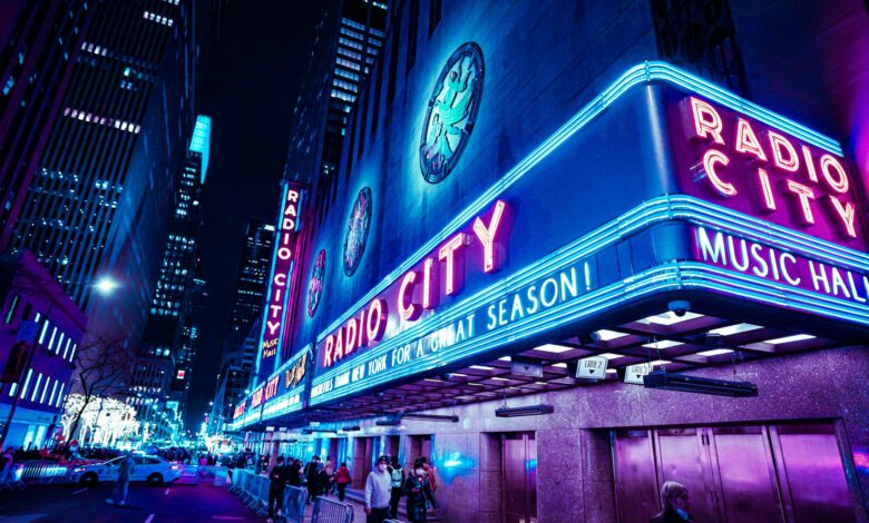 Iconic Radio City Music Hall with neon lights at night in New York City.