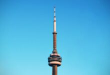 Close-up of Toronto's CN Tower reaching into a cloudless blue sky.