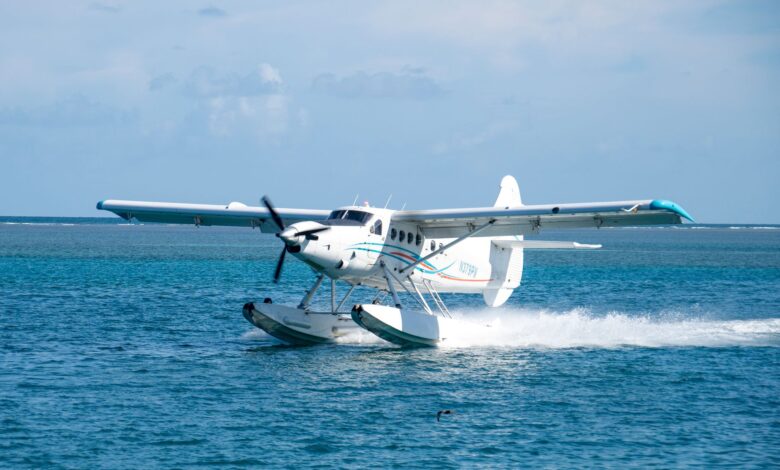 Seaplane gracefully landing on turquoise ocean waters in Key West, Florida.