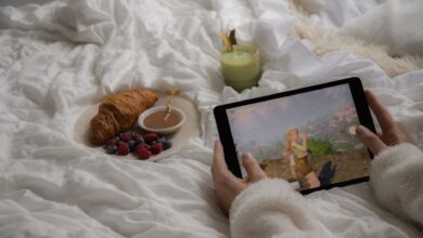 Enjoy a cozy morning in bed with a croissant, berries, matcha latte, and a tablet game.