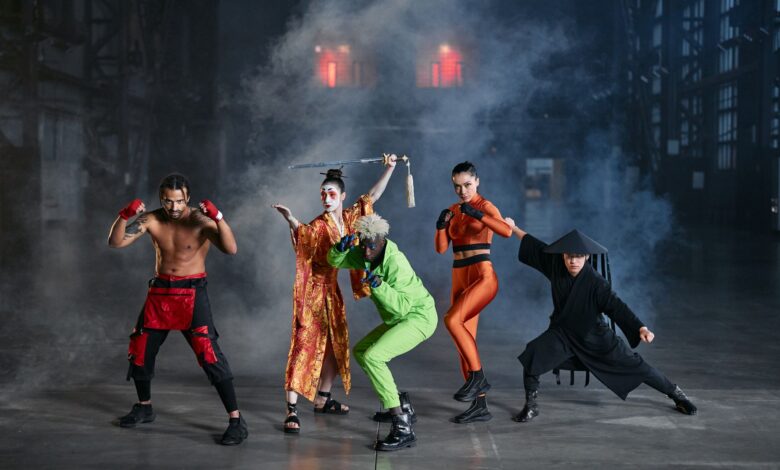 A diverse group of cosplayers posing as game characters indoors, surrounded by smoke.