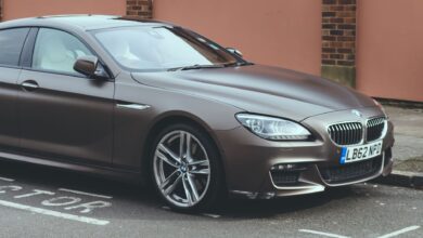 Luxury BMW 6 Series coupe parked on an urban street, showcasing sleek design and elegance.