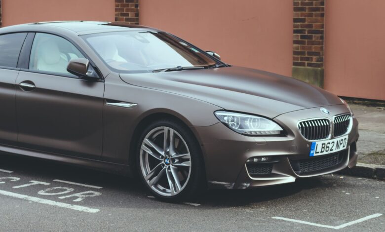 Luxury BMW 6 Series coupe parked on an urban street, showcasing sleek design and elegance.