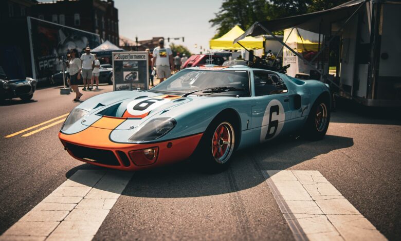 Classic blue and orange vintage race car showcased at an outdoor car show in London, Ohio.