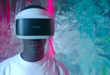 Teen enjoying virtual reality experience with vibrant neon lights.