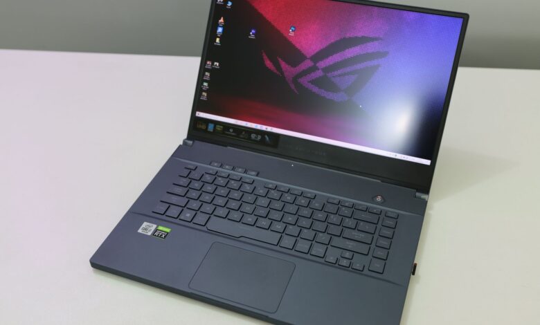A sleek and modern laptop featuring a black keyboard on a white desk top, showcasing technology and design.