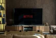Cozy living room featuring a large TV displaying Netflix, perfect for entertainment.