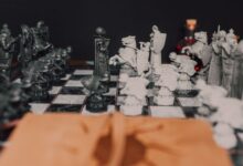 Detailed close-up of a medieval themed chess set highlighting strategy and artistry in black and white.