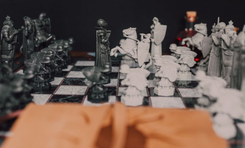 Detailed close-up of a medieval themed chess set highlighting strategy and artistry in black and white.