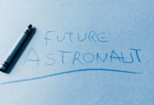 Handwritten text 'Future Astronaut' on blue paper with a crayon.