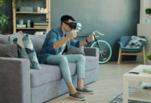 Man using VR headset on couch, enjoying a virtual reality experience.