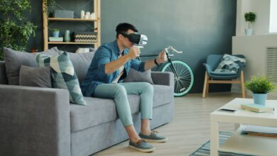 Man using VR headset on couch, enjoying a virtual reality experience.