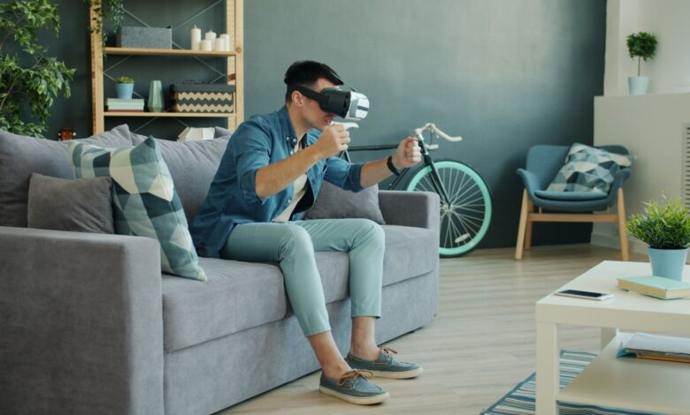 Man using VR headset on couch, enjoying a virtual reality experience.