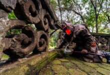 Spooky Halloween cosplay set in a lush Mexican forest with stone ruins.