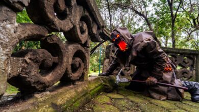 Spooky Halloween cosplay set in a lush Mexican forest with stone ruins.