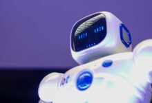 A modern humanoid robot with digital face and luminescent screen, symbolizing innovation in technology.