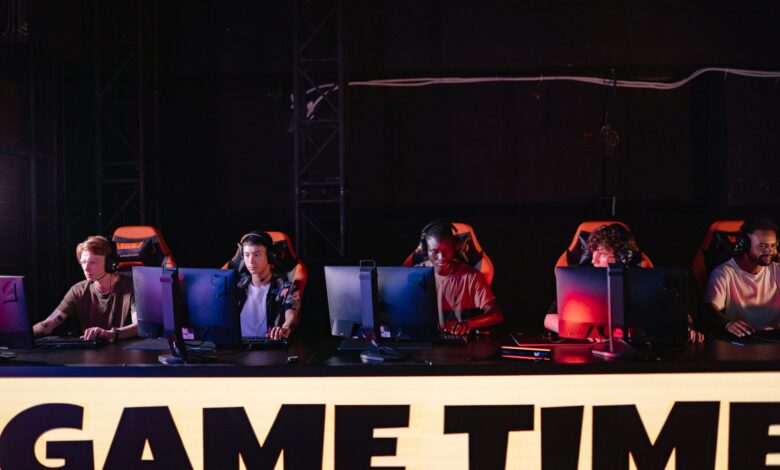 A group of diverse gamers participating in an online eSports tournament indoors.