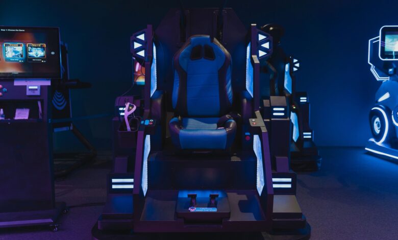 High-tech gaming simulator chair in an indoor arcade setting with neon lights.
