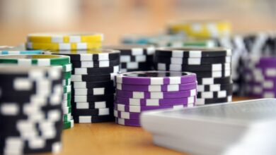 A close-up shot of stacked poker chips and playing cards on a table, perfect for casino and gambling themes.