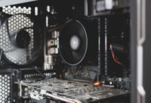 Detailed view of internal computer hardware showcasing cooling fan, RAM, and circuitry.