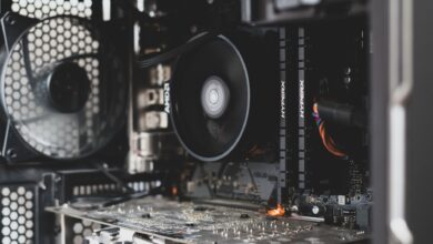 Detailed view of internal computer hardware showcasing cooling fan, RAM, and circuitry.