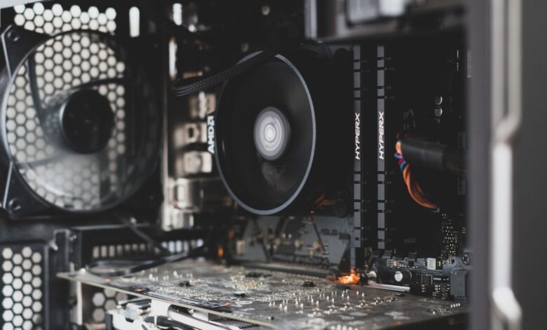 Detailed view of internal computer hardware showcasing cooling fan, RAM, and circuitry.