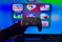 Close-up of a gaming controller against a vibrant screen in London, England.
