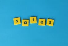 Yellow Scrabble tiles spelling 'sales' on a vibrant blue background. Perfect for marketing and business themes.