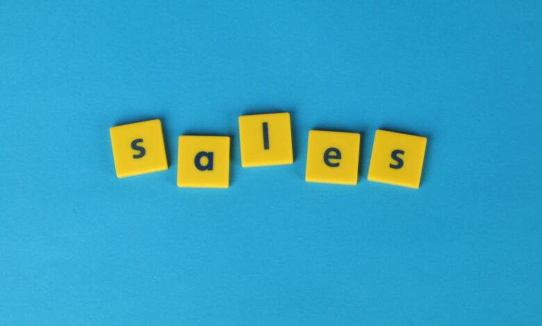 Yellow Scrabble tiles spelling 'sales' on a vibrant blue background. Perfect for marketing and business themes.