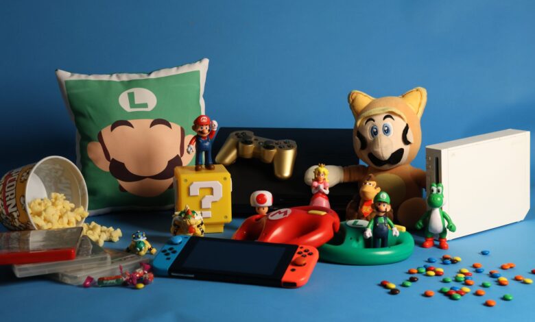 A vibrant assortment of gaming collectibles, including Nintendo figures, consoles, and candy on a blue background.