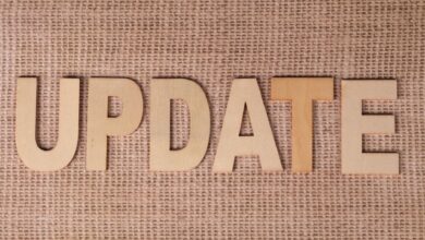 Wooden letters arranged to spell 'UPDATE' on a textured burlap surface, perfect for business or project imagery.