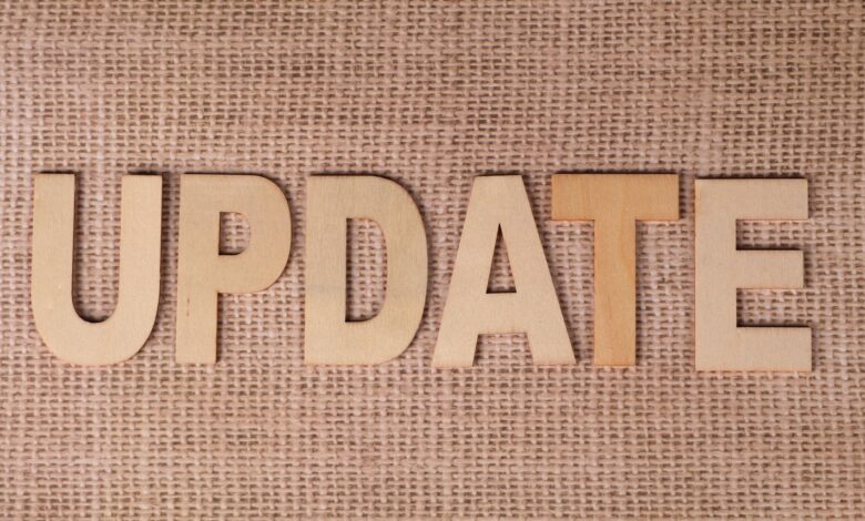 Wooden letters arranged to spell 'UPDATE' on a textured burlap surface, perfect for business or project imagery.