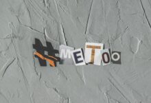 Text art 'MeToo' on concrete background highlighting social movement themes.