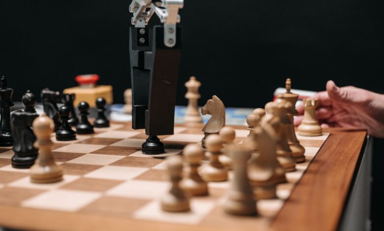 Close-up of a robotic arm playing chess against a human, showcasing AI technology in a classic board game setting.